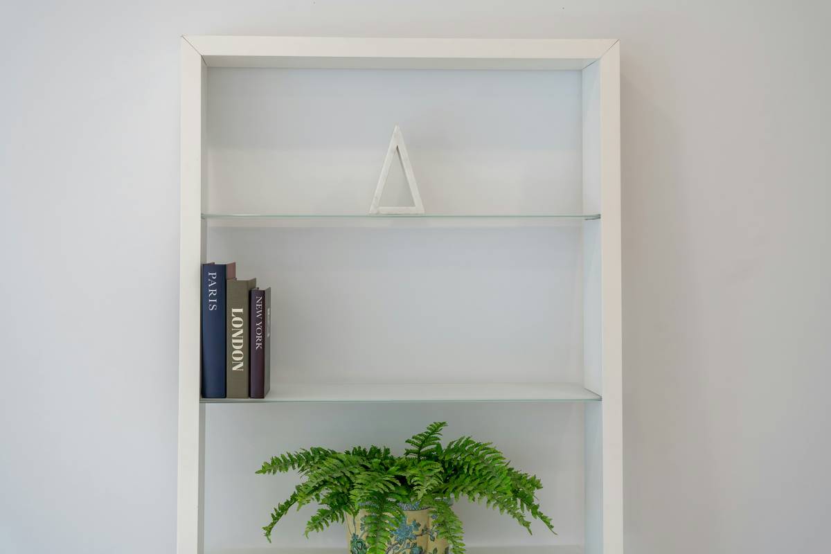 Modern living room featuring a sleek smart shelf with integrated wireless charging and ambient lighting